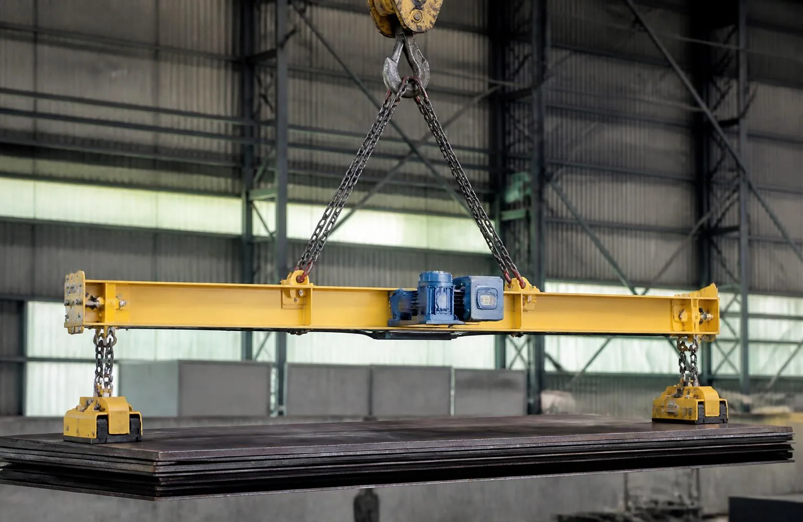 Engineered below-the-hook lifting beam suspended above a steel load